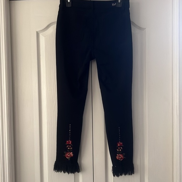 Earl Jeans Denim - Earl Jeans with fringe and embroidered floral design on back leg.
